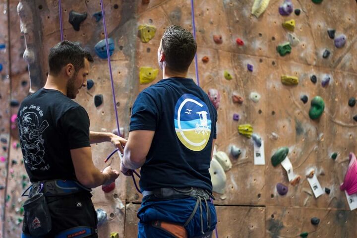 men-rock-wall-climb